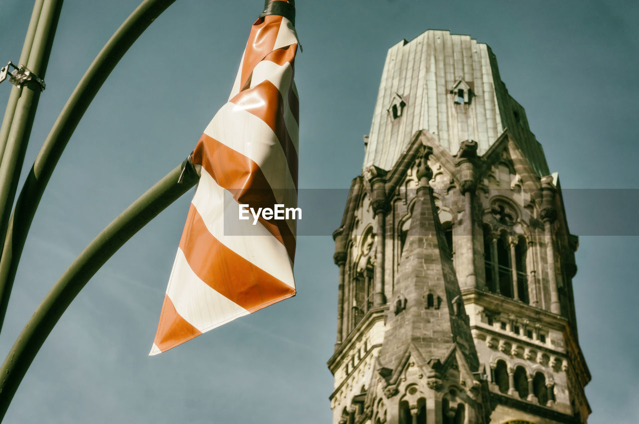 LOW ANGLE VIEW OF FLAGS AGAINST TEMPLE