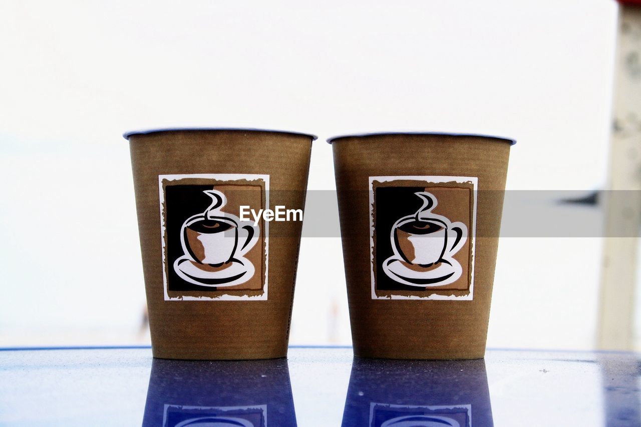 Close-up of two coffee cups on table