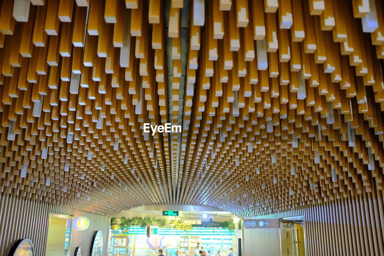 LOW ANGLE VIEW OF ILLUMINATED CEILING IN BUILDING