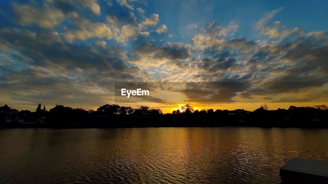 SILHOUETTE TREES BY LAKE AGAINST SKY DURING SUNSET