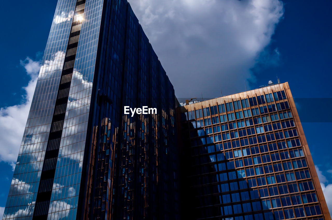 Low angle view of modern buildings against sky