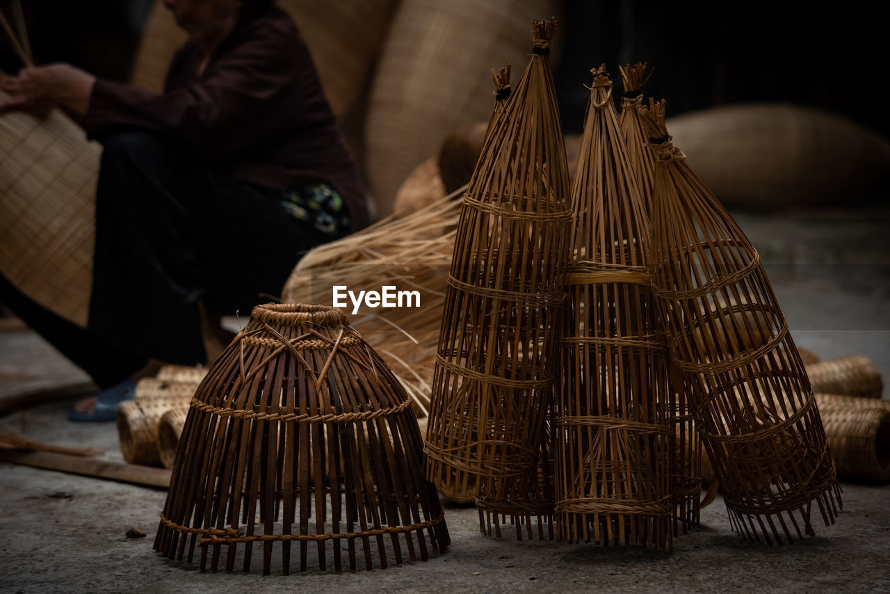 Low section of man sitting on wicker basket