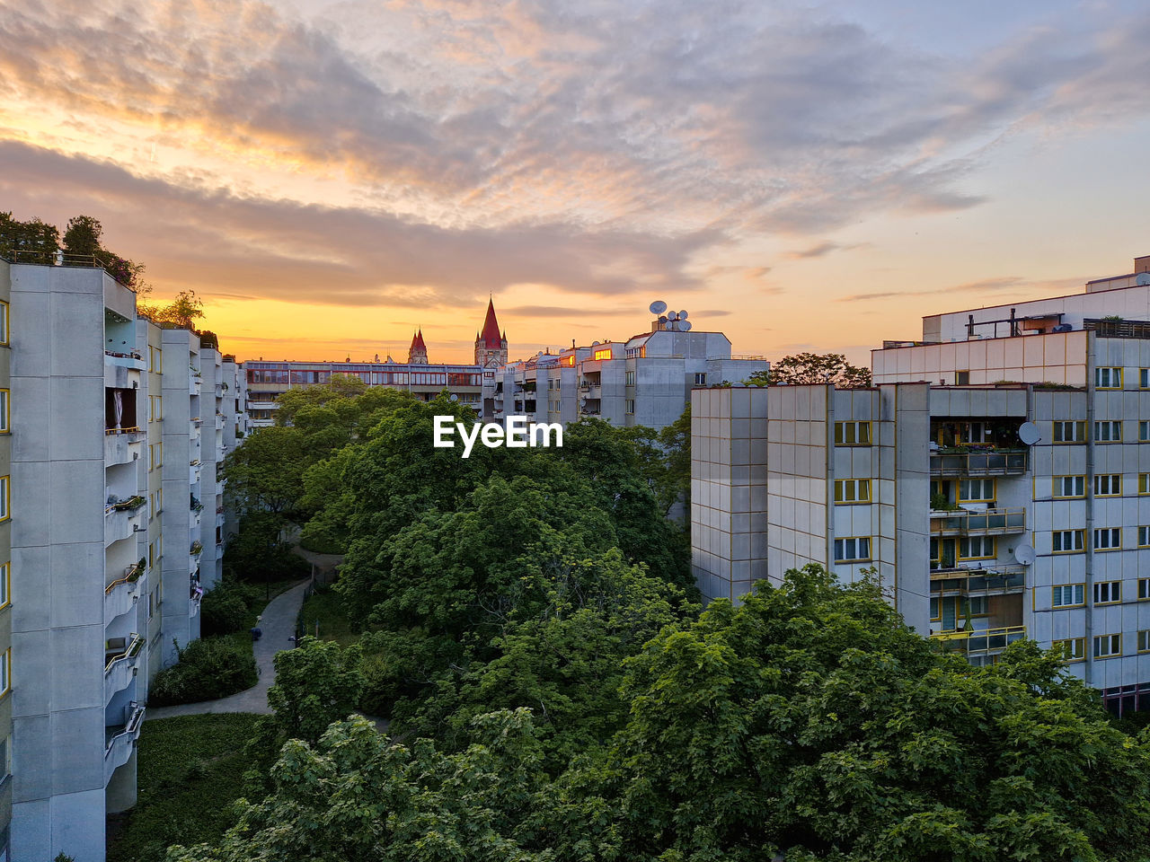 architecture, built structure, building exterior, city, urban area, building, sunset, sky, cityscape, skyline, nature, residential district, plant, cloud, travel, landmark, travel destinations, landscape, construction industry, tree, business finance and industry, neighbourhood, residential area, environment, house, tourism, outdoors, no people, industry, urban skyline, town, tower block, history, dusk, high angle view, the past, skyscraper, downtown, street