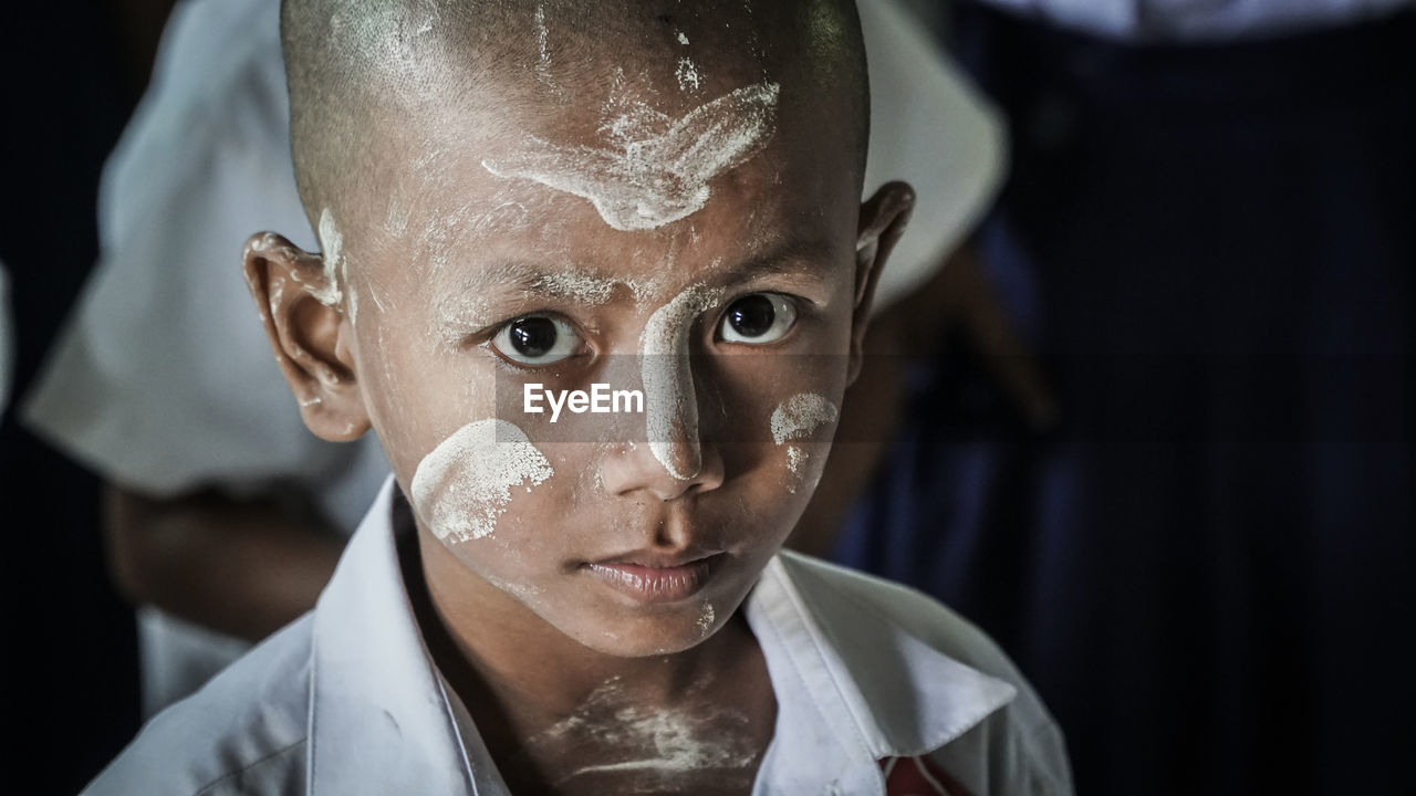 Close-up portrait of boy with painted face