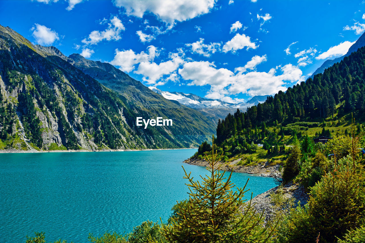 Scenic view of lake and mountains against sky