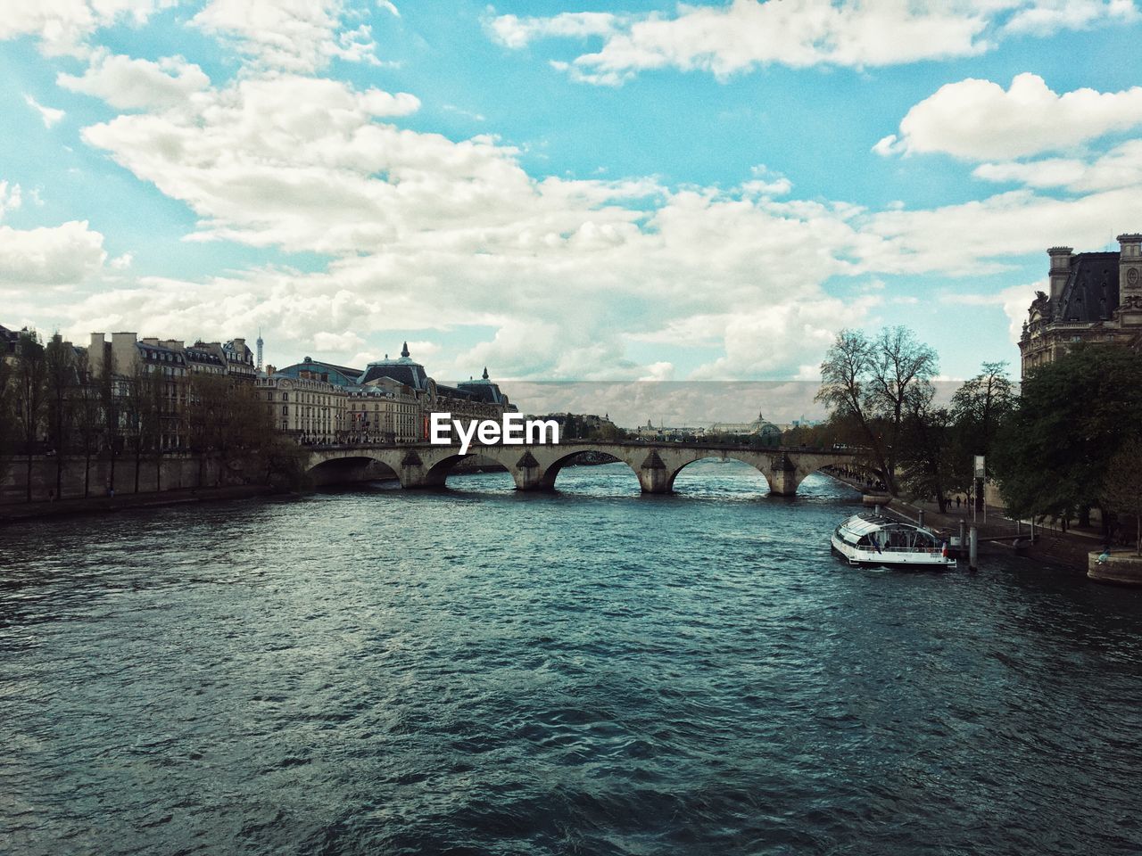 View of bridge over river against cloudy sky