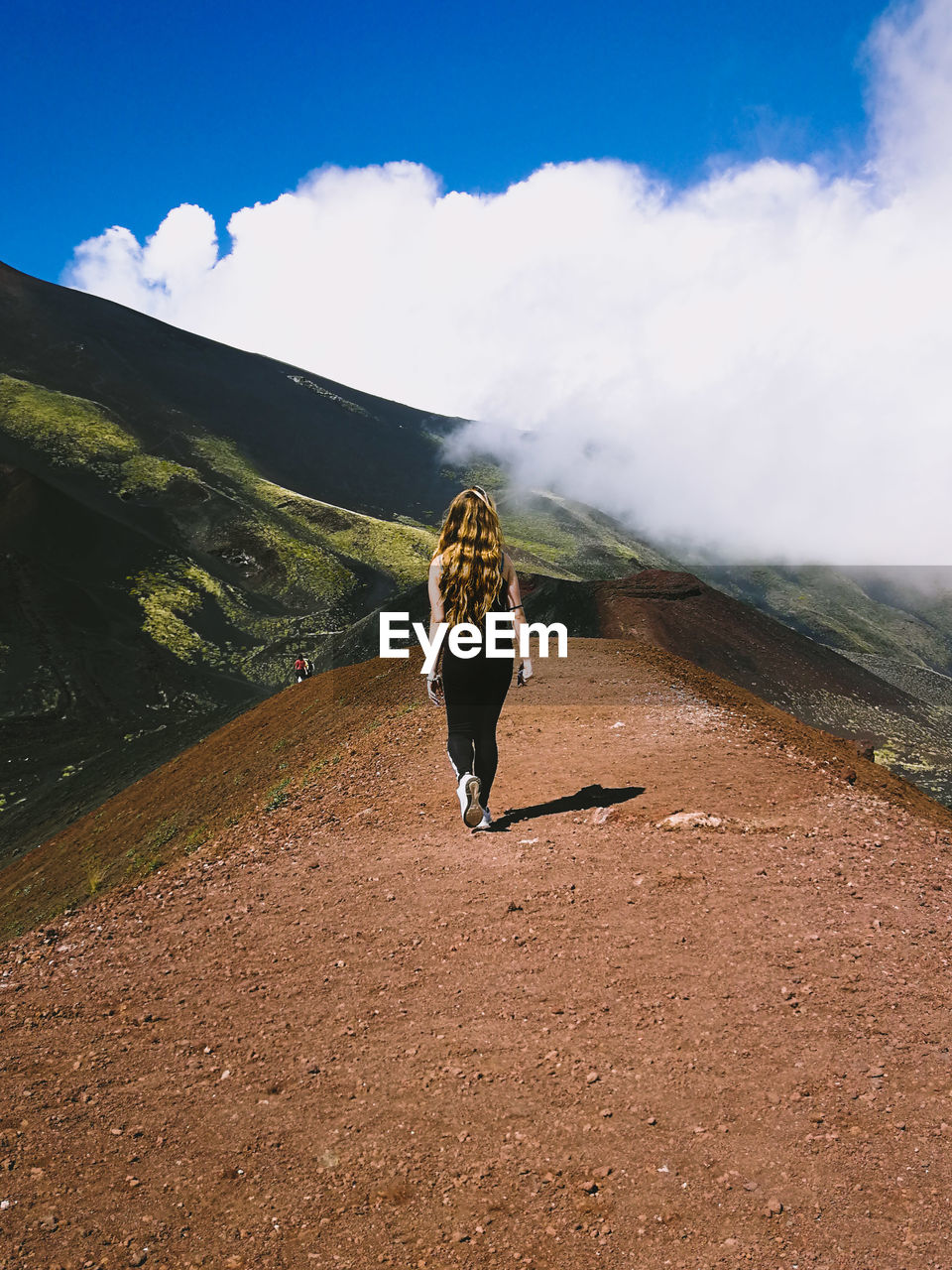 FULL LENGTH REAR VIEW OF WOMAN WALKING ON MOUNTAIN