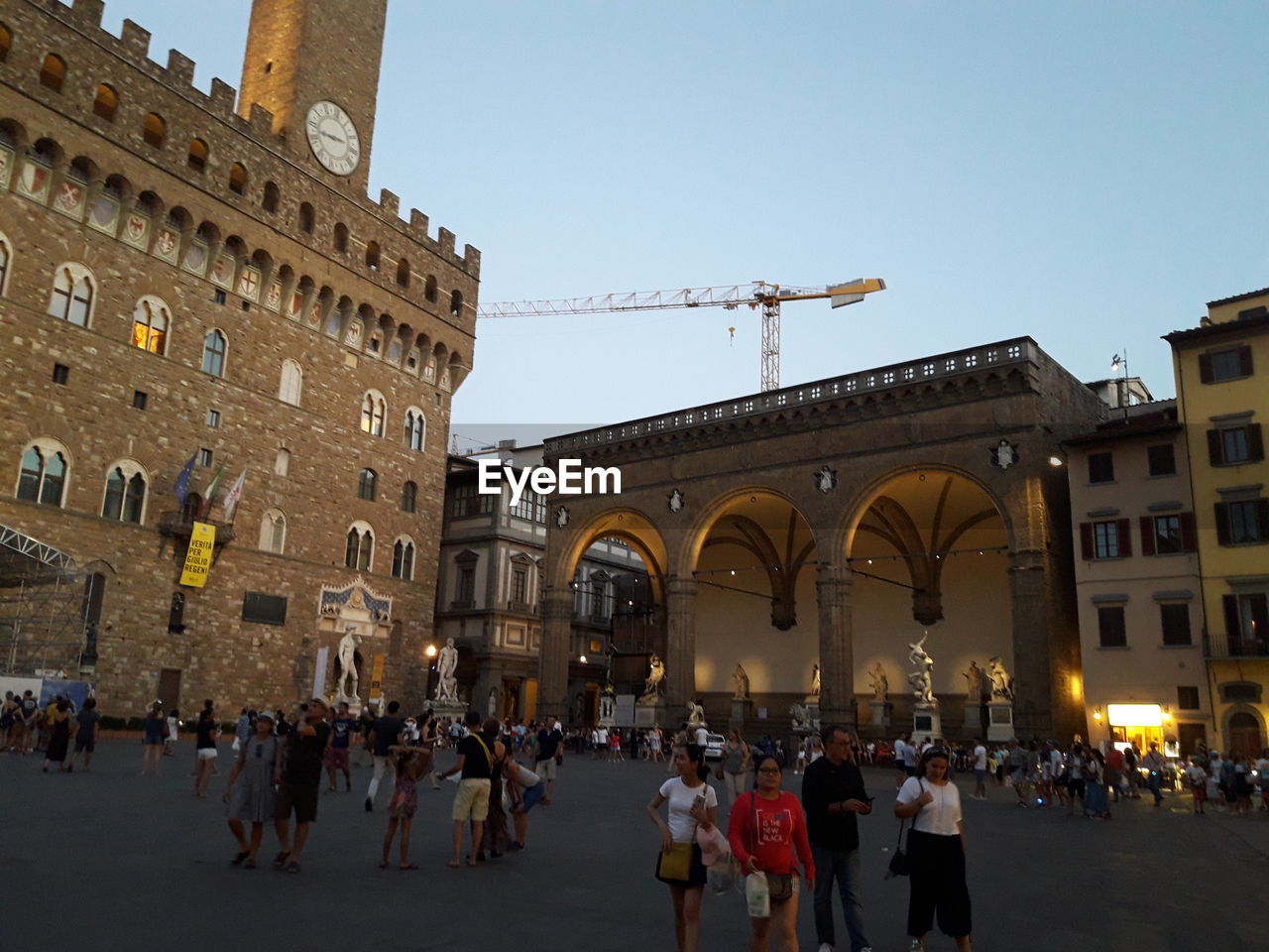 GROUP OF PEOPLE IN FRONT OF BUILDINGS