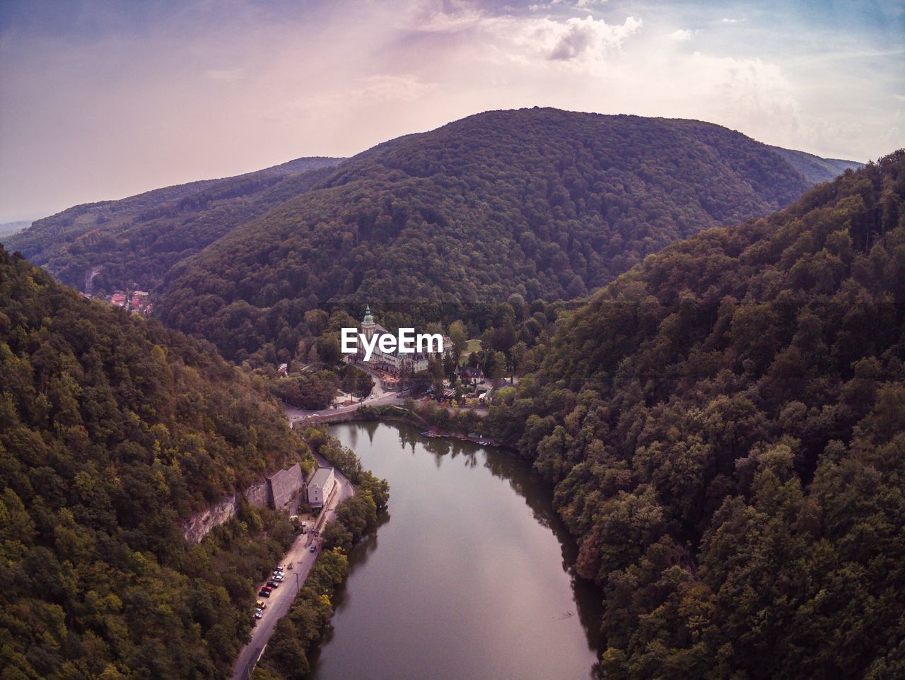 Scenic view of river amidst mountains against sky