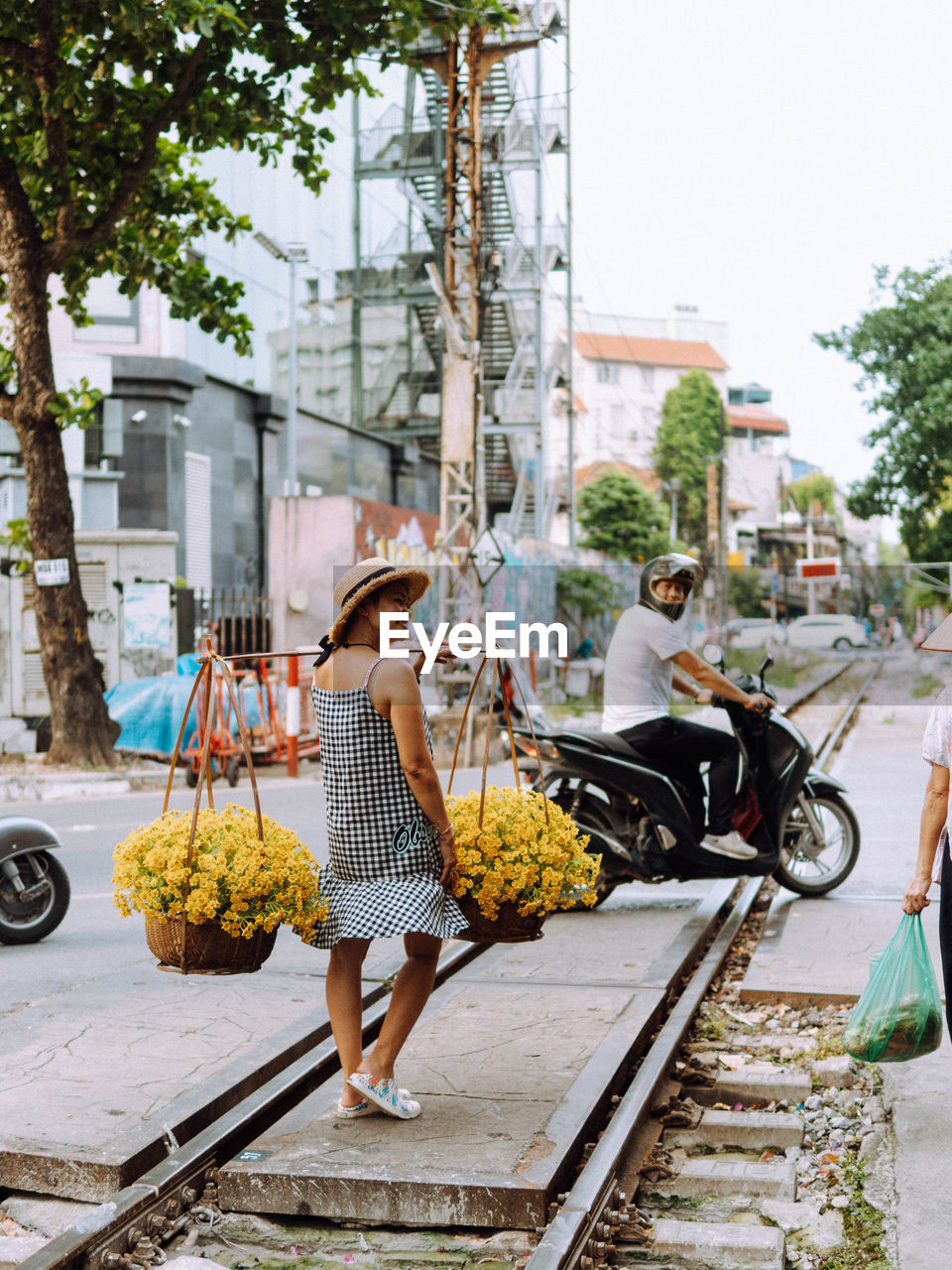 rear view of woman sitting on road
