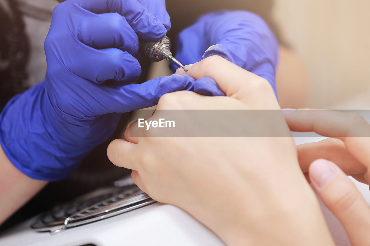 cropped hands of doctor examining patient in hospital