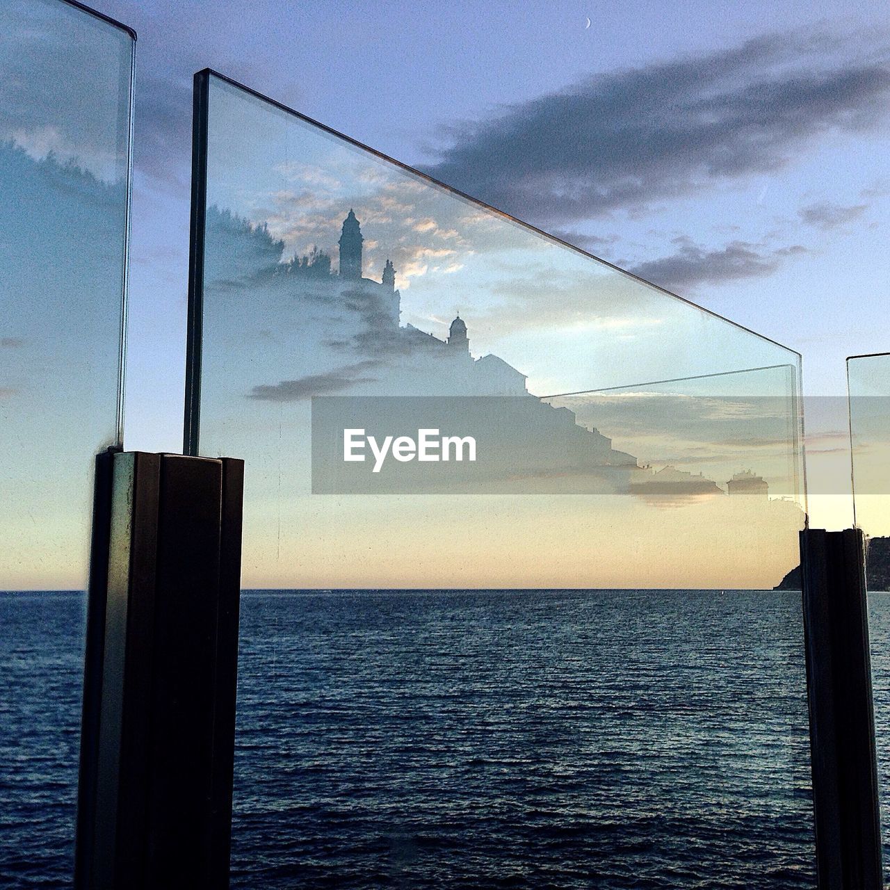 Scenic view of sea during sunset seen through glass