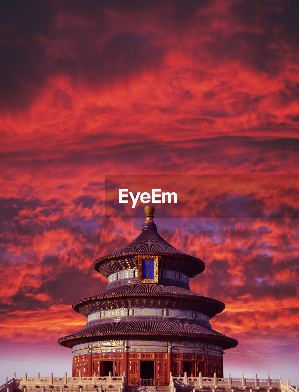 Low angle view of temple against dramatic sky