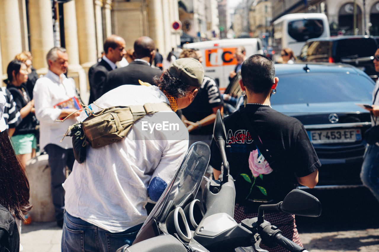 REAR VIEW OF PEOPLE ON STREET