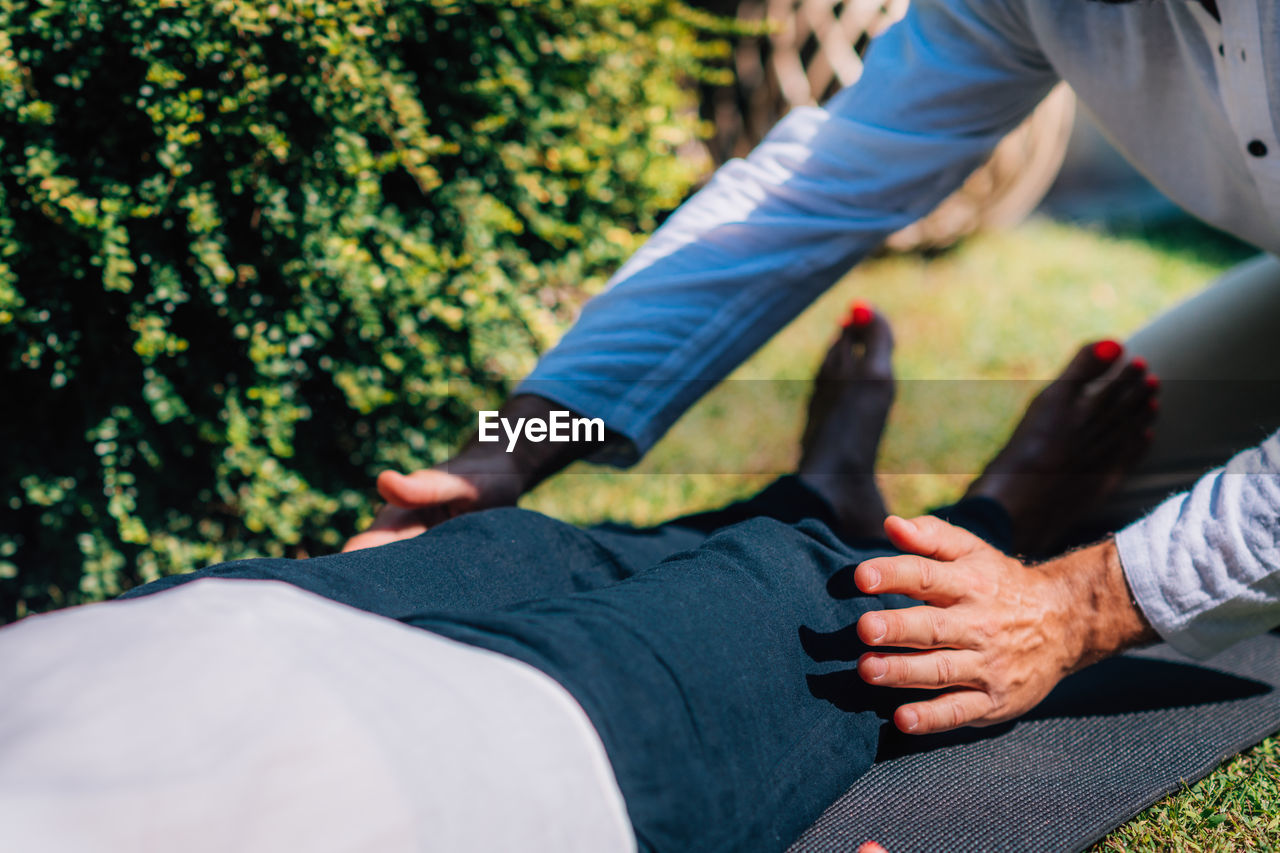 Hands of a reiki therapist healing and balancing energy points in feet. energy healing concept