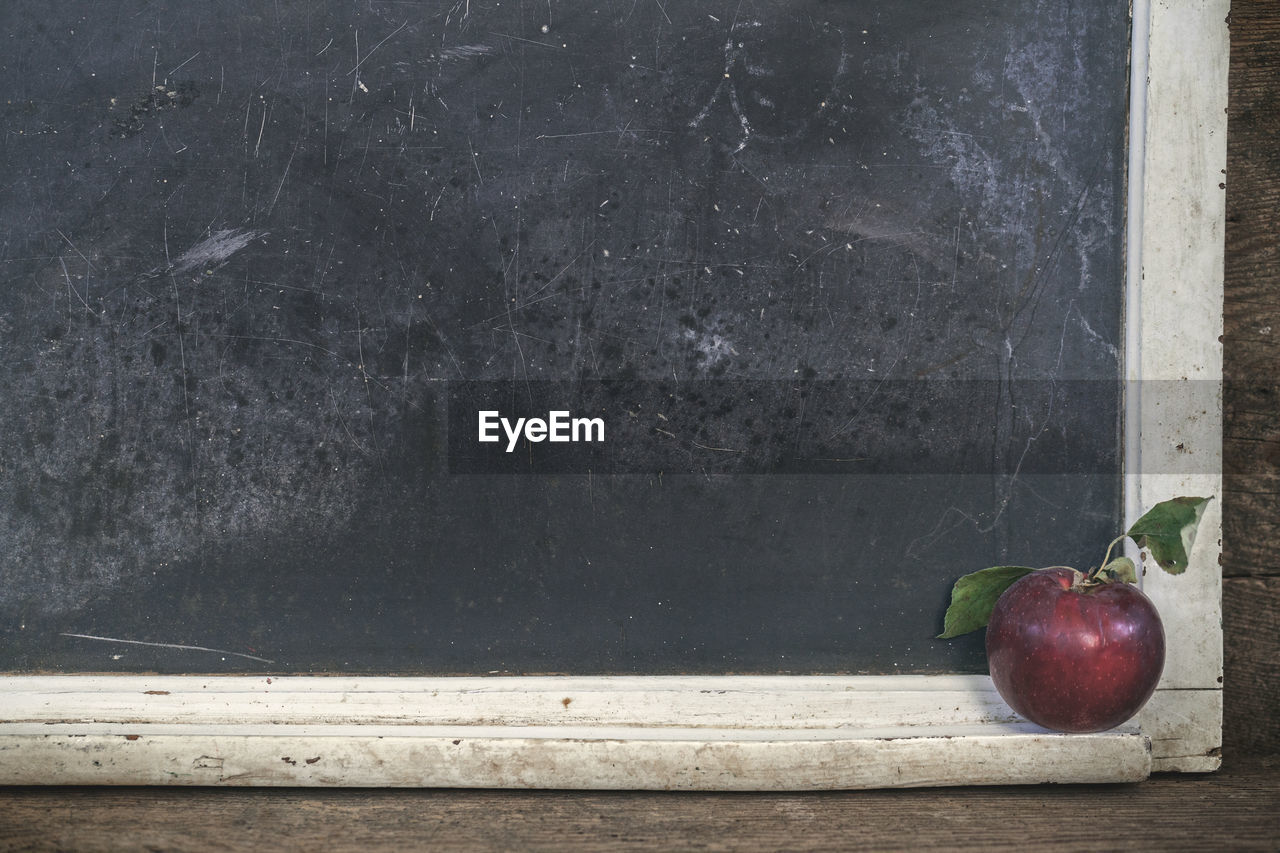 Apple against blackboard in classroom