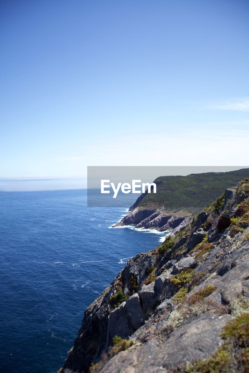 Scenic view of sea against clear blue sky