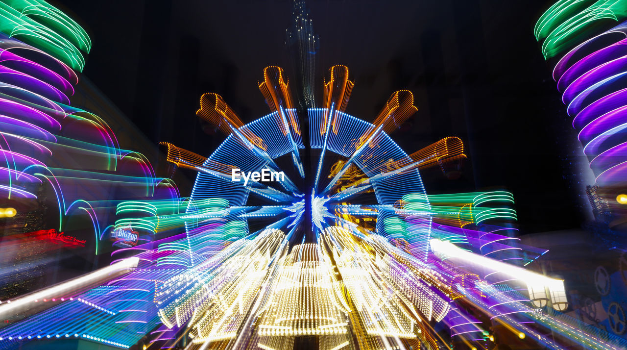 ILLUMINATED LIGHT TRAILS ON AMUSEMENT PARK