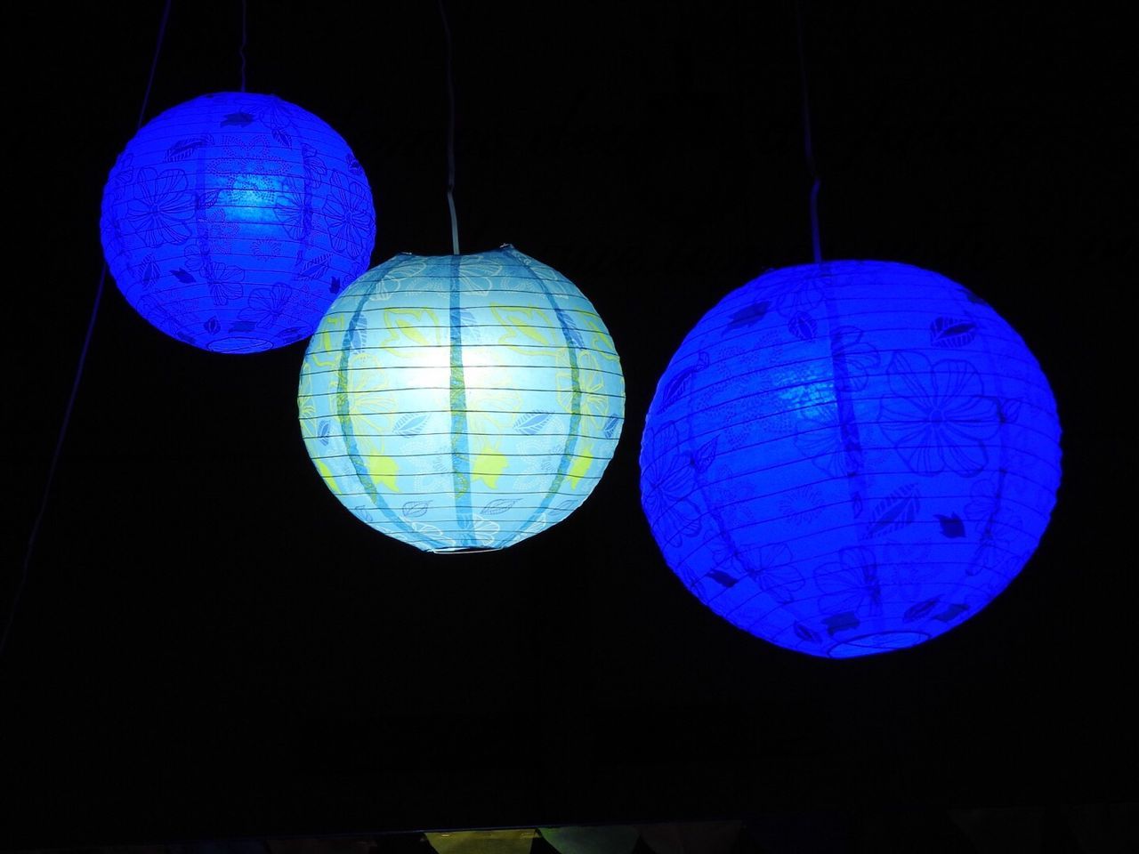 LOW ANGLE VIEW OF LANTERN HANGING AGAINST BLACK BACKGROUND