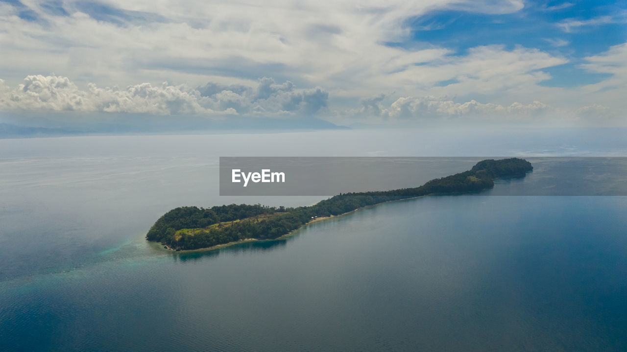 Small tropical big liguid island in the blue sea with a coral reef and the beach. big cruz island