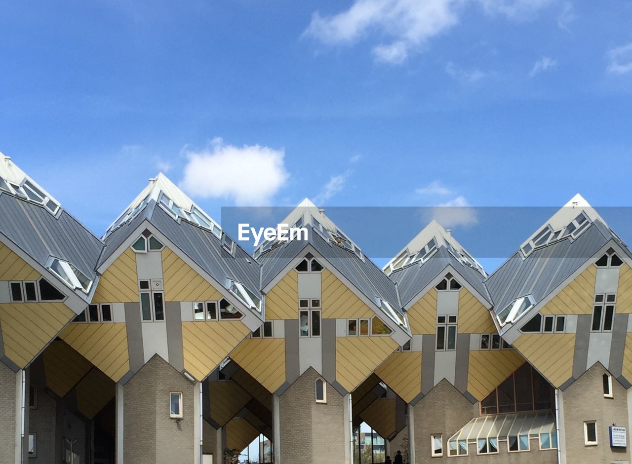 Low angle view of buildings against blue sky