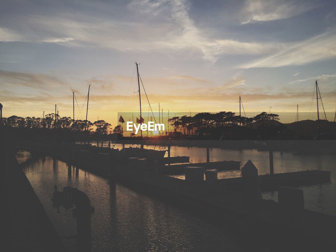 Silhouette of harbor during sunset