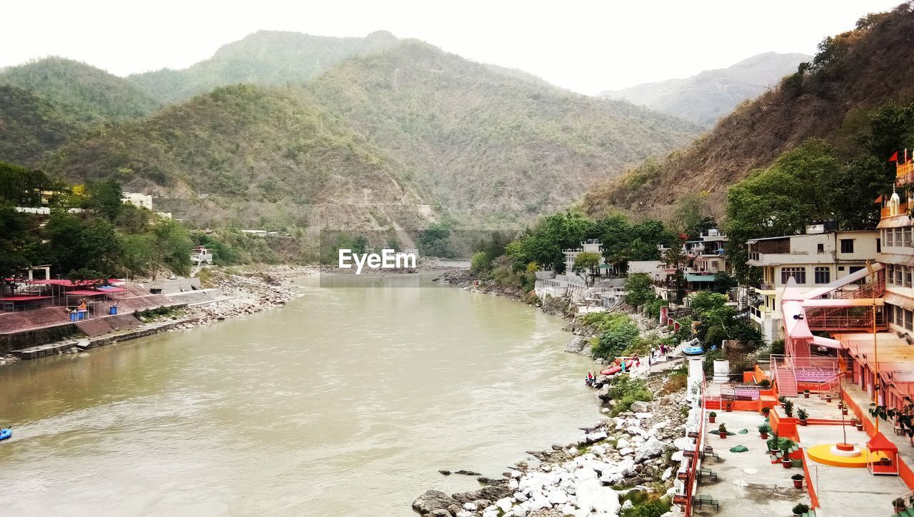 HIGH ANGLE VIEW OF RIVER AMIDST MOUNTAINS