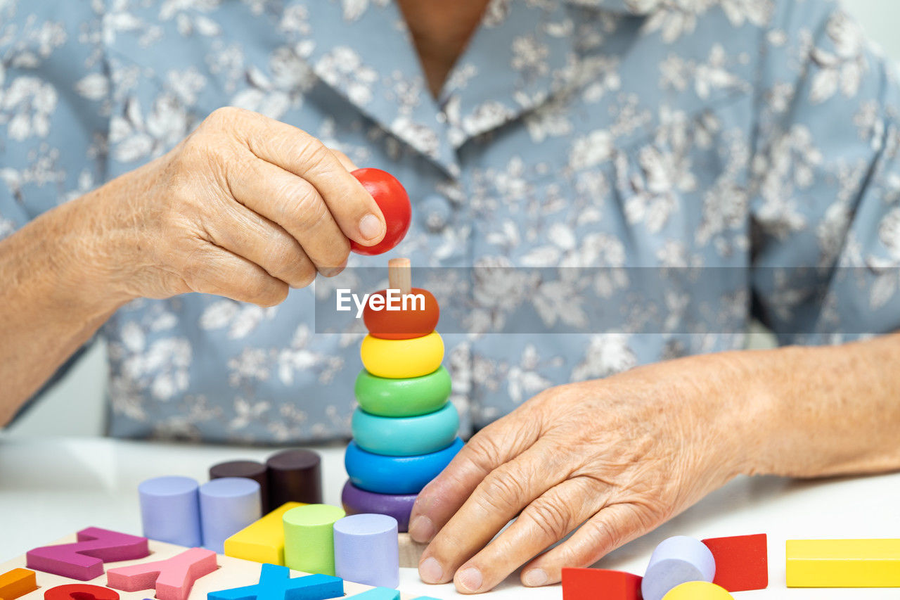 midsection of man playing with pills