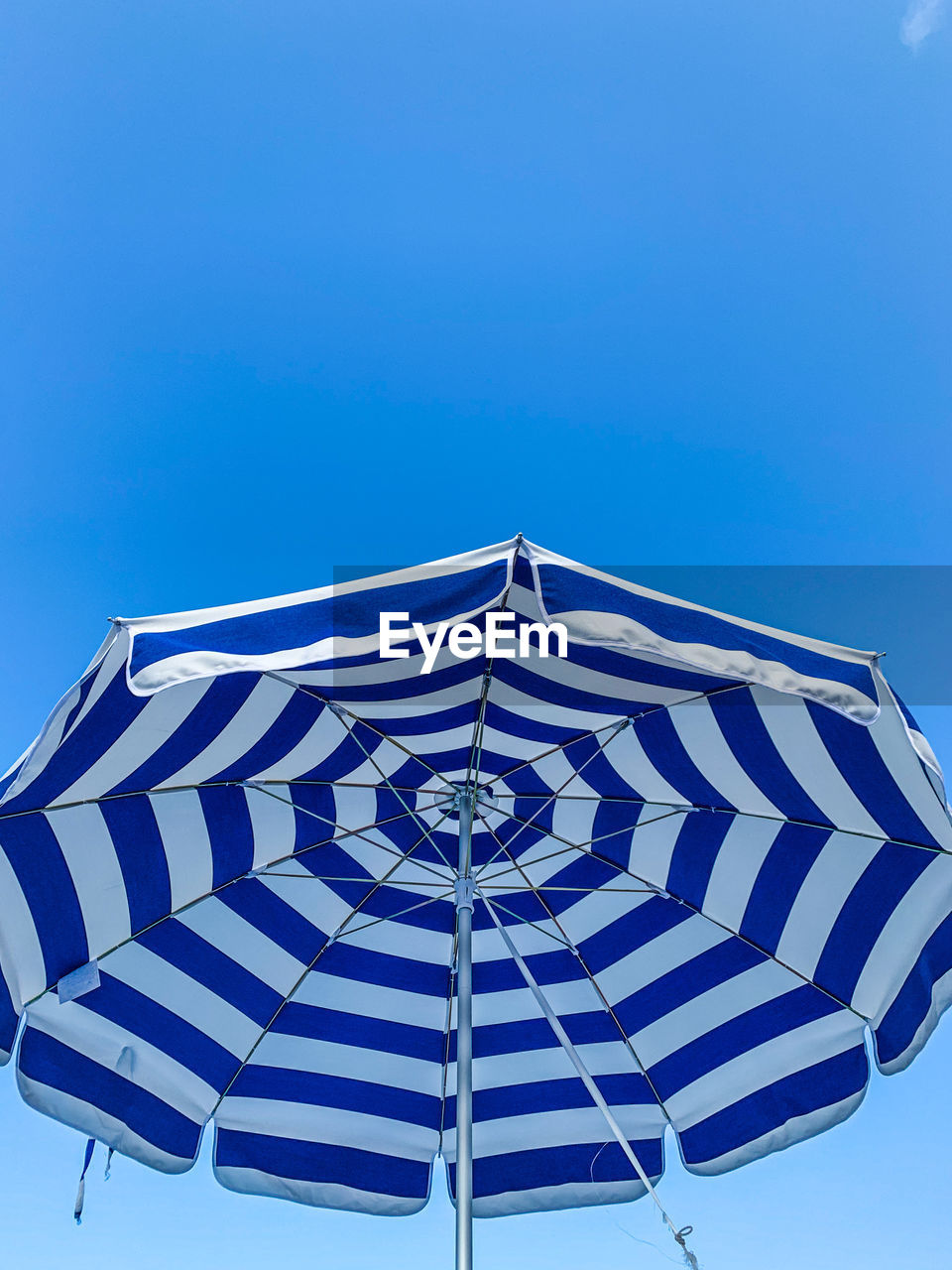 umbrella, blue, sky, protection, parasol, nature, security, clear sky, no people, day, fashion accessory, outdoors, sunshade, striped, pattern, low angle view, sunny, beach umbrella