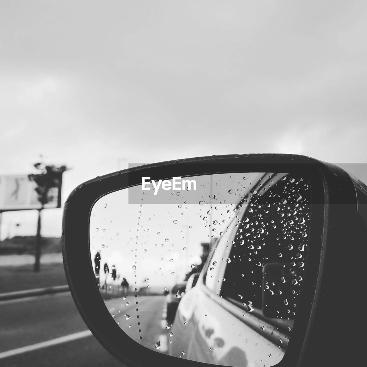 CLOSE-UP OF RAINDROPS ON SIDE-VIEW MIRROR