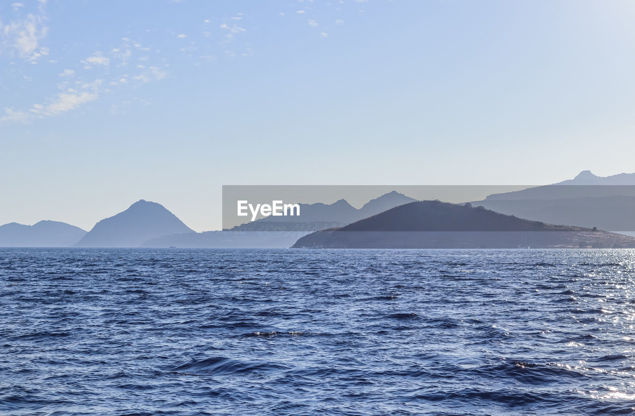 scenic view of sea and mountains against sky