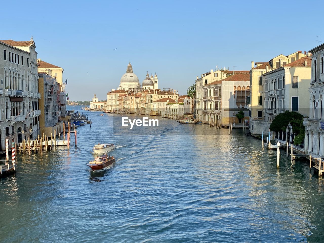 water, architecture, building exterior, nautical vessel, built structure, travel destinations, transportation, travel, mode of transportation, city, gondola, body of water, canal, nature, sky, tourism, waterway, boat, building, town, clear sky, vehicle, sea, waterfront, cityscape, channel, bridge, place of worship, gondolier, trip, vacation, day, history, blue, watercraft, holiday, craft, religion, outdoors, sunny, the past, harbor, old, no people, sunlight, bell tower, ship, reflection, residential district