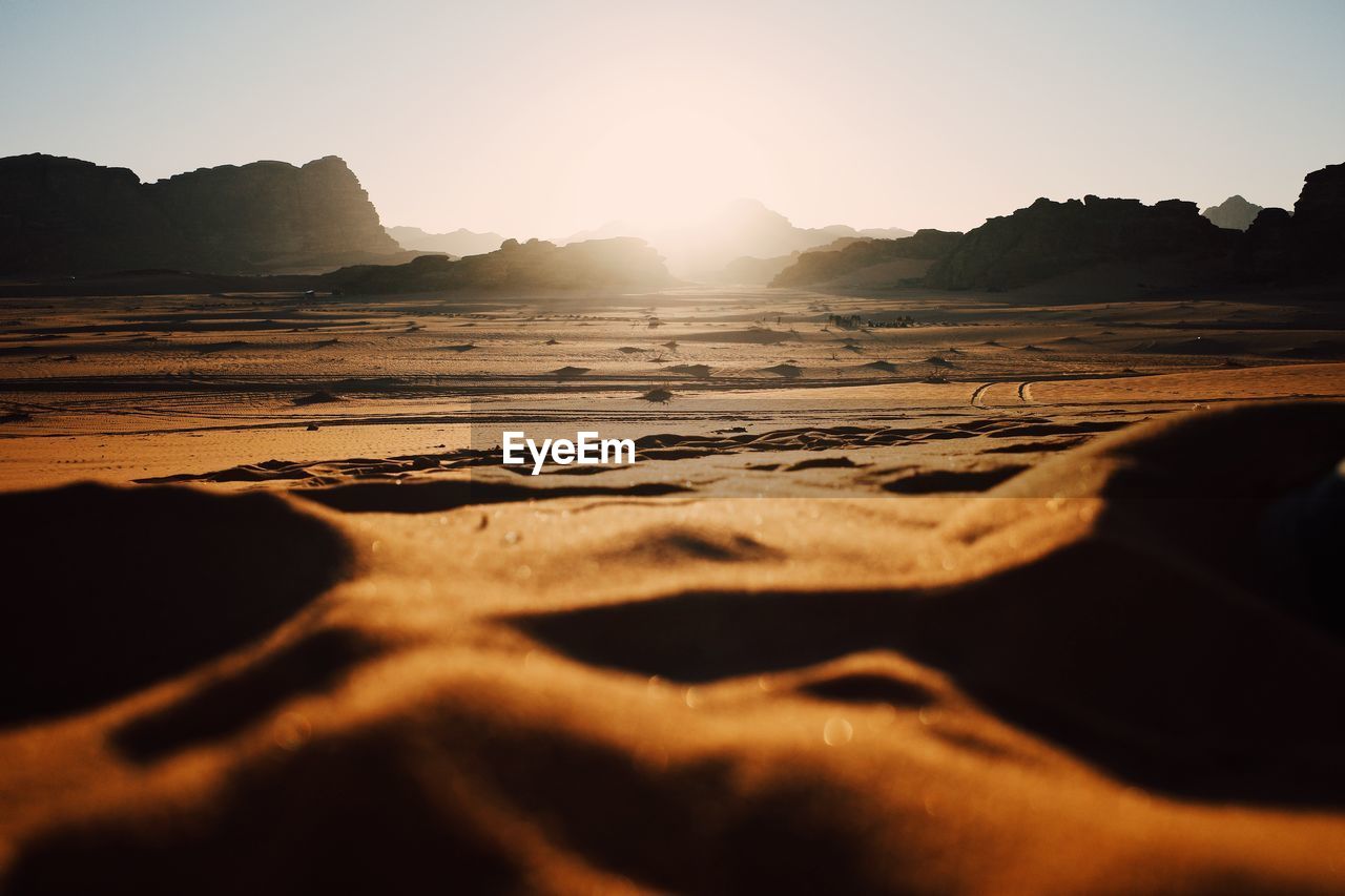 Scenic view of desert against sky during sunset