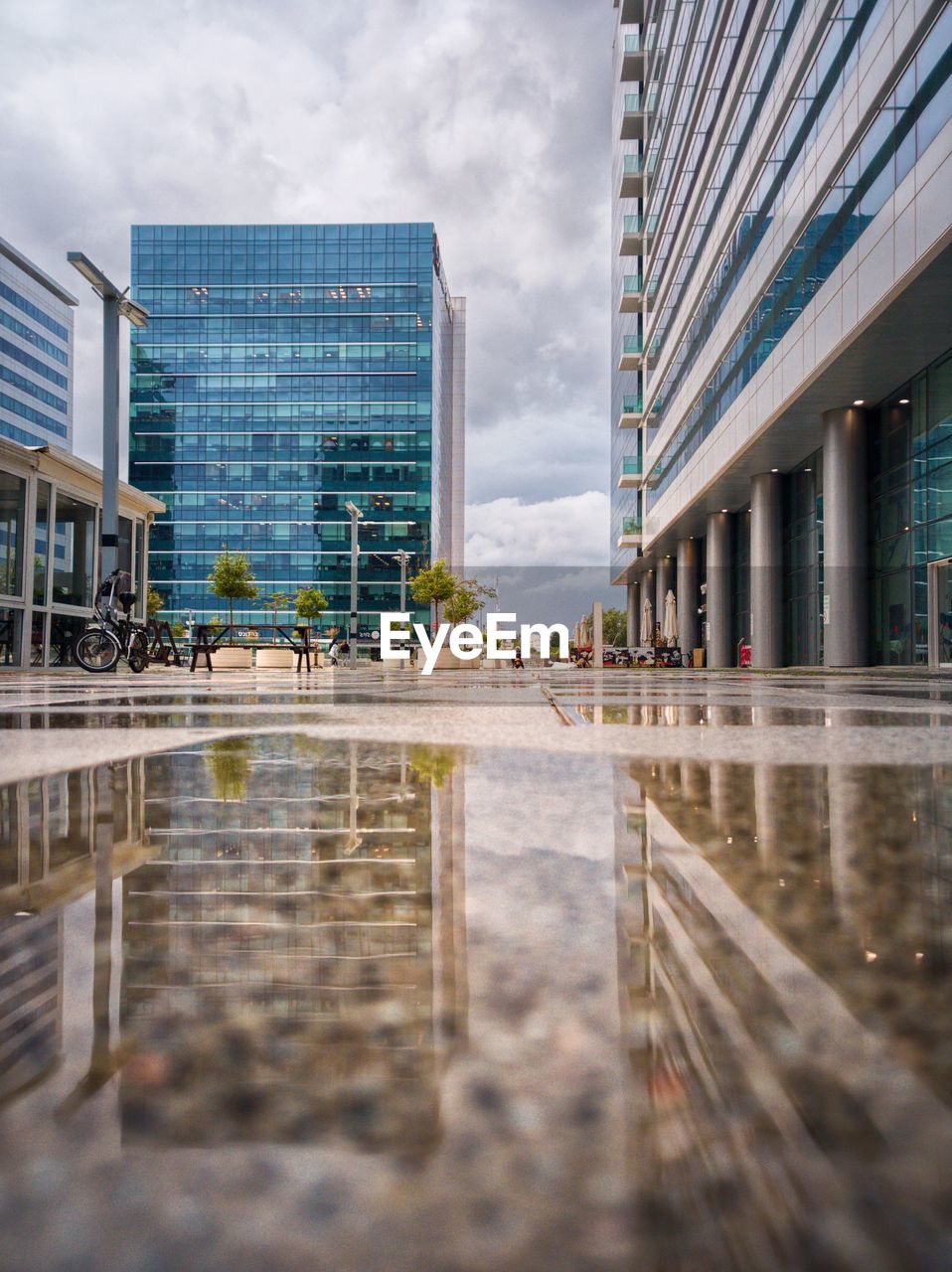 Reflection of buildings in city against sky