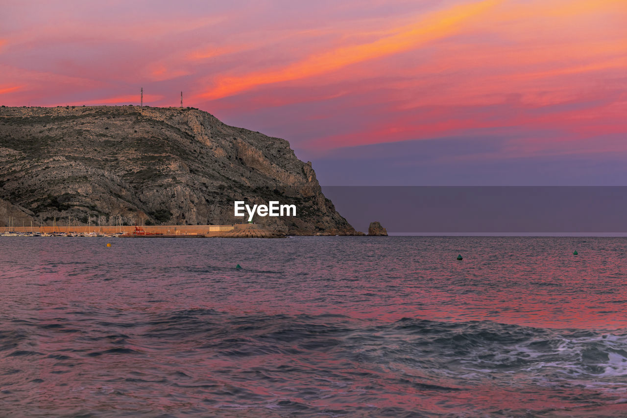 Scenic view of sea against orange sky