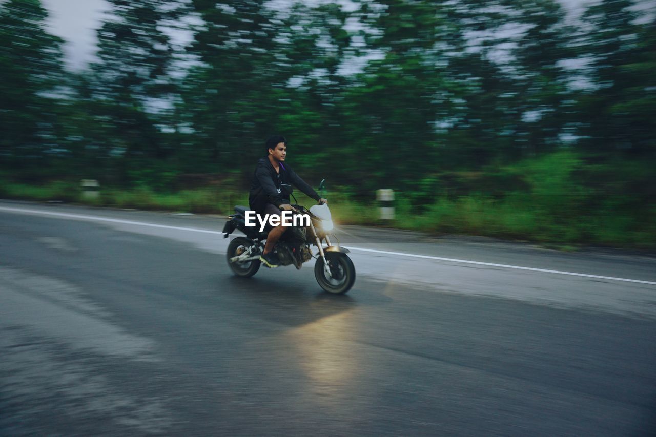 Man riding motorcycle on road