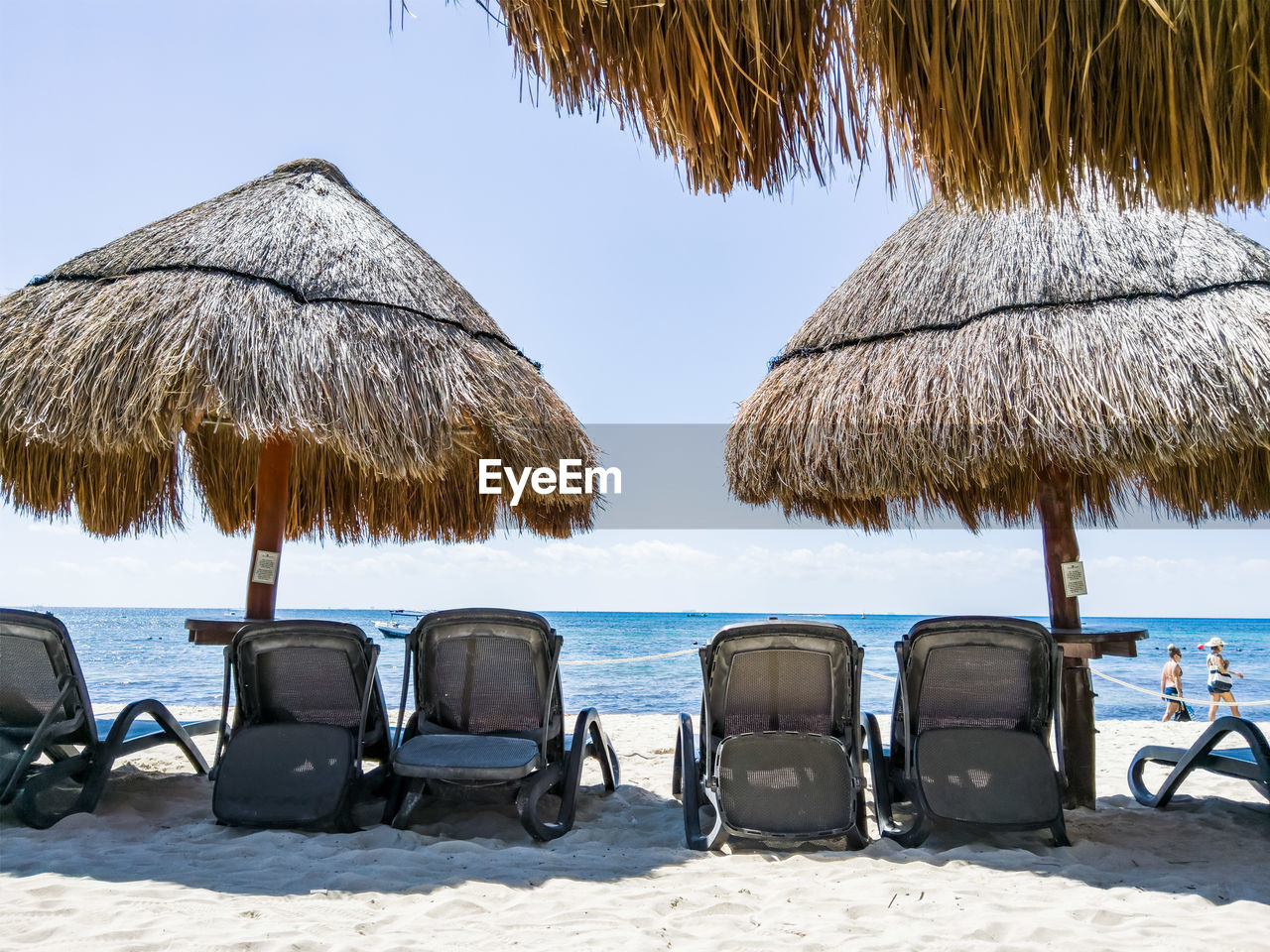 CHAIRS ON BEACH AGAINST SKY