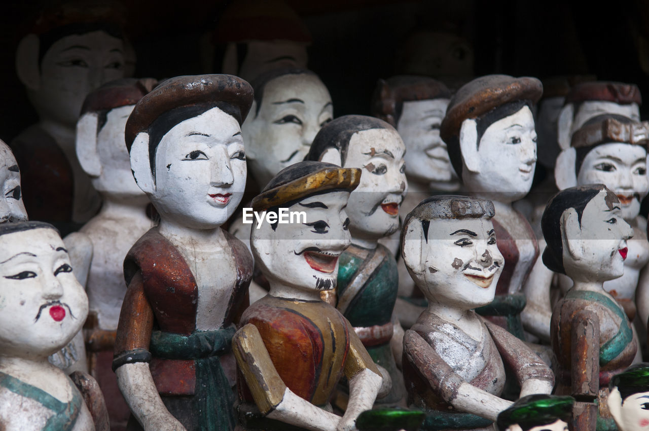Close-up of wooden puppets for sale at market stall