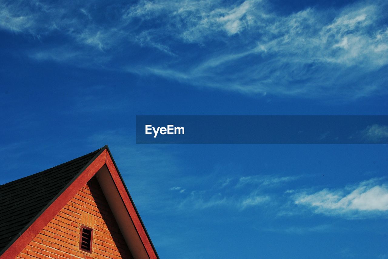 Low angle view of house against blue sky