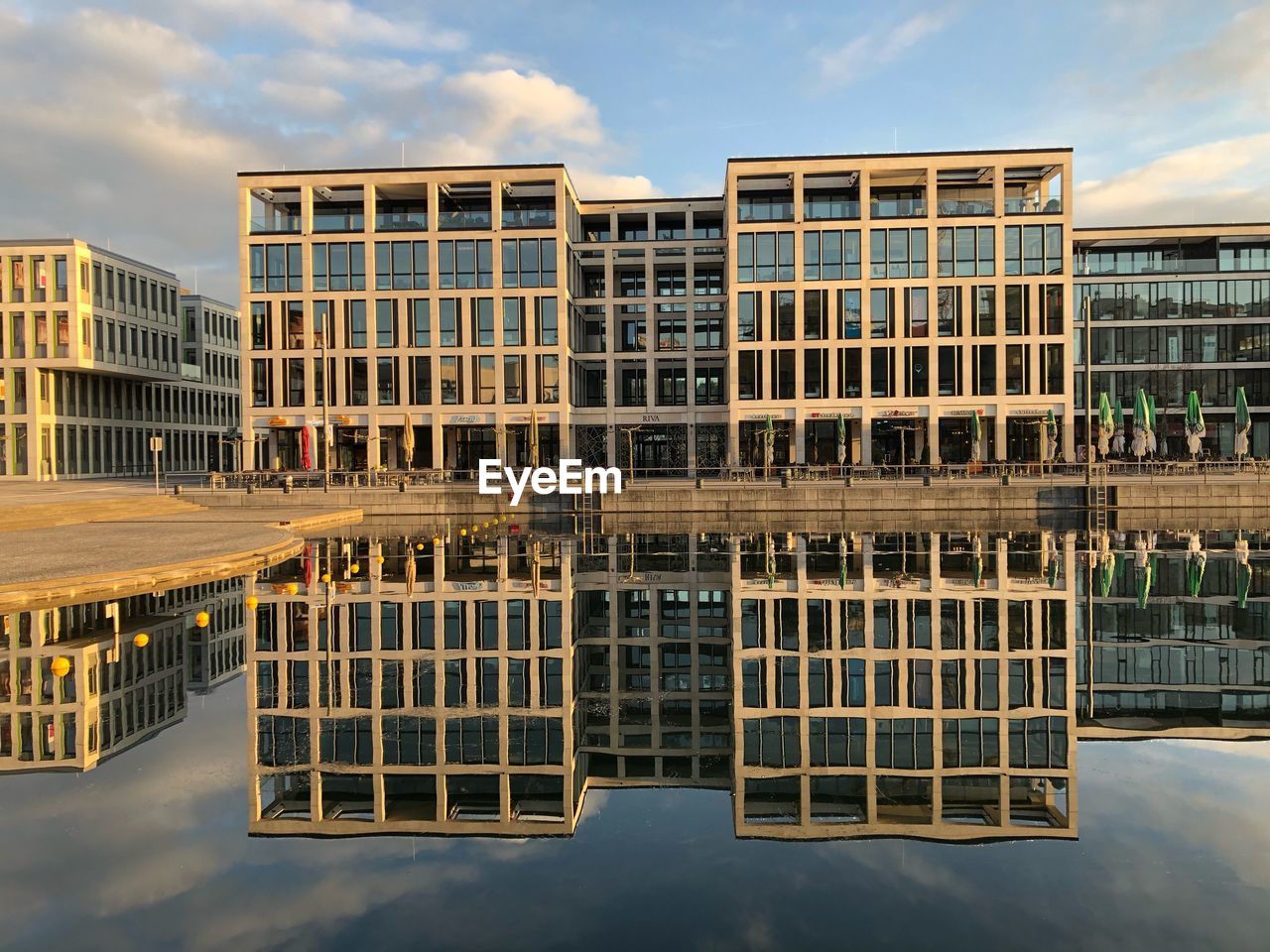 Reflection of building in lake against sky