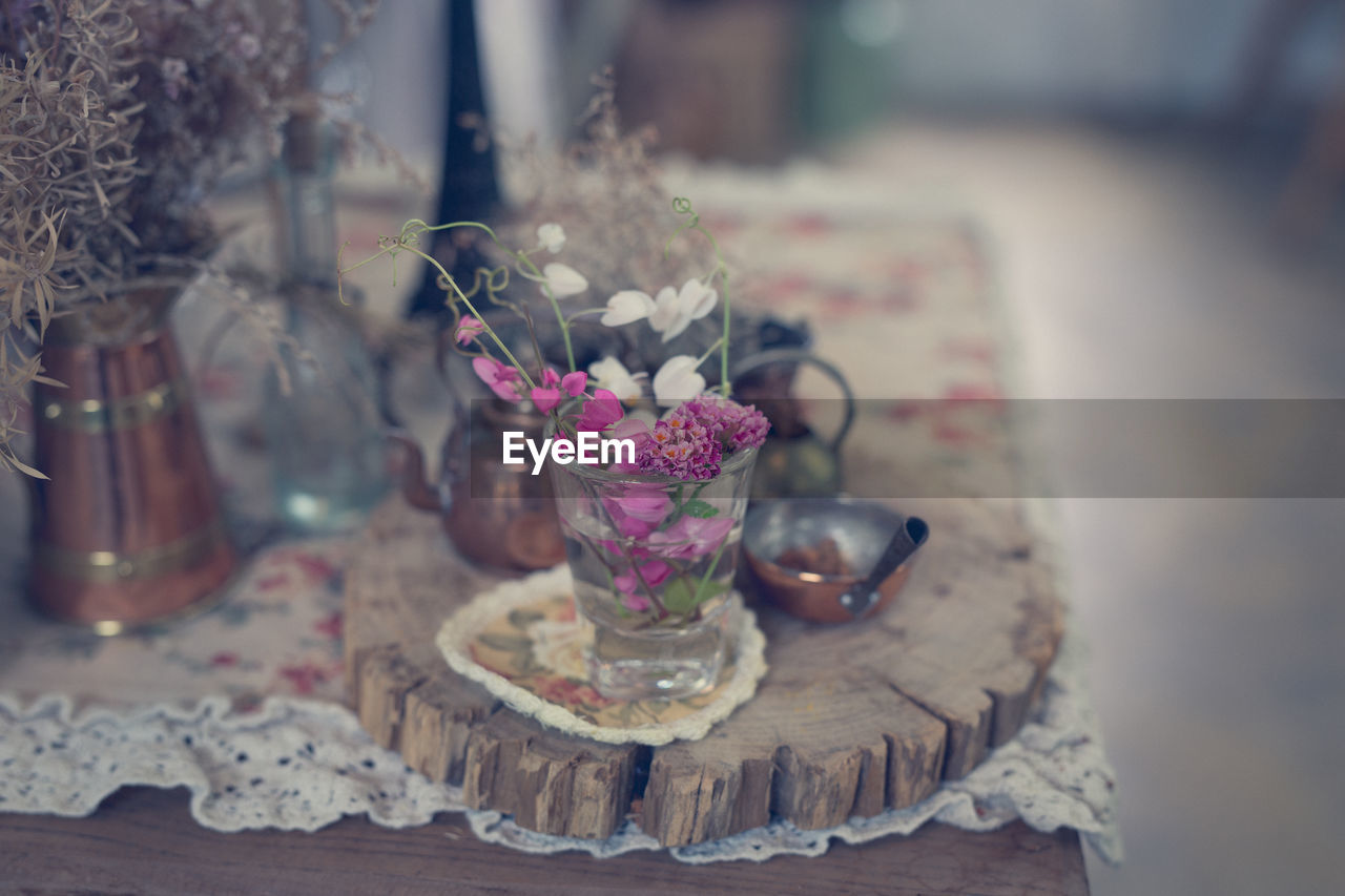 Close-up of pink roses in glass vase on table