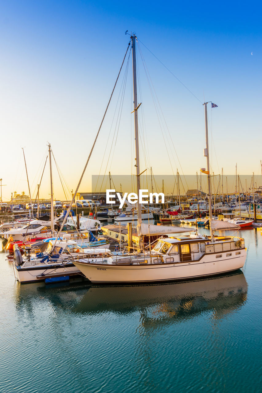 BOATS MOORED IN HARBOR