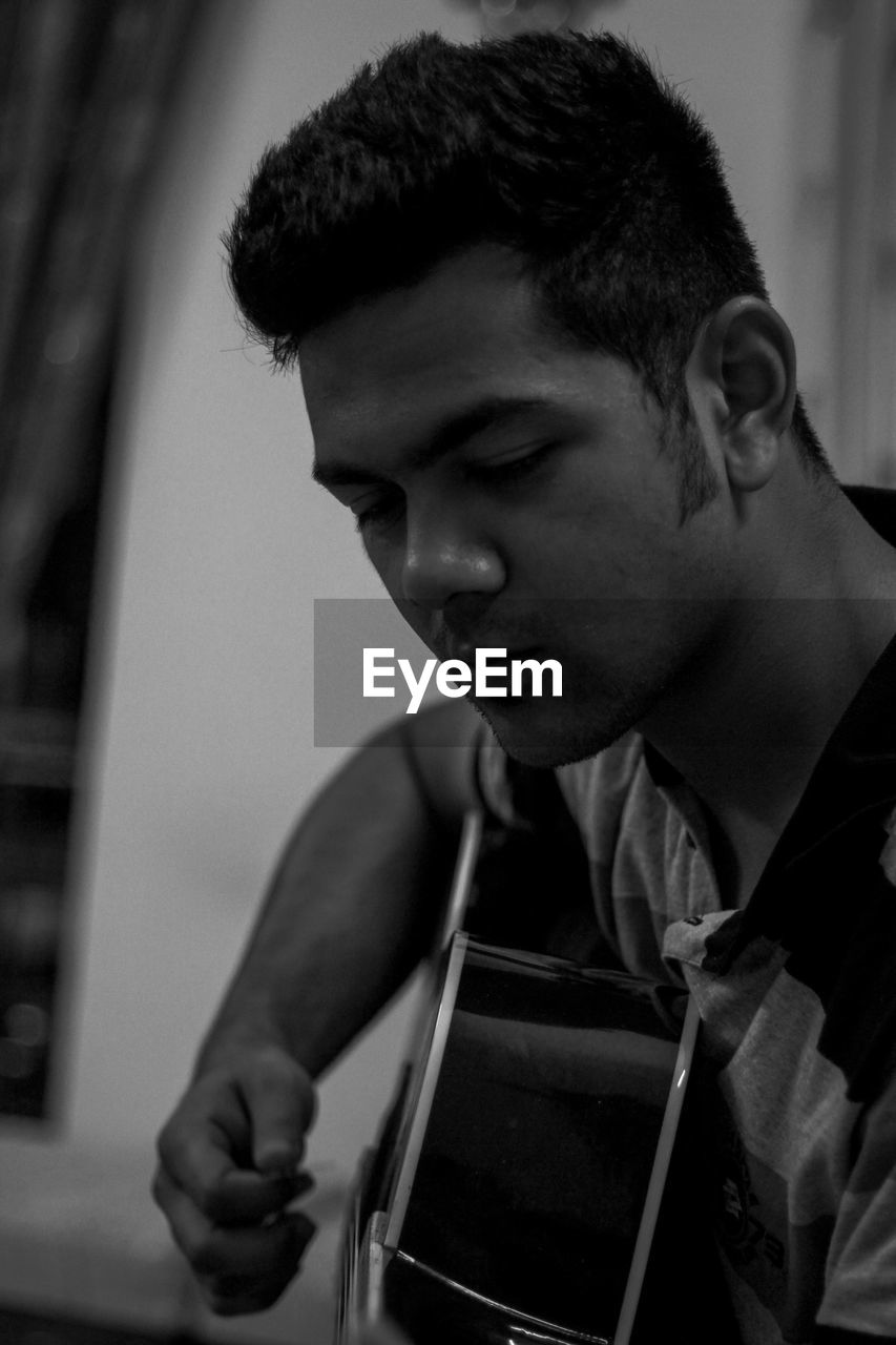 A boy practicing guitar