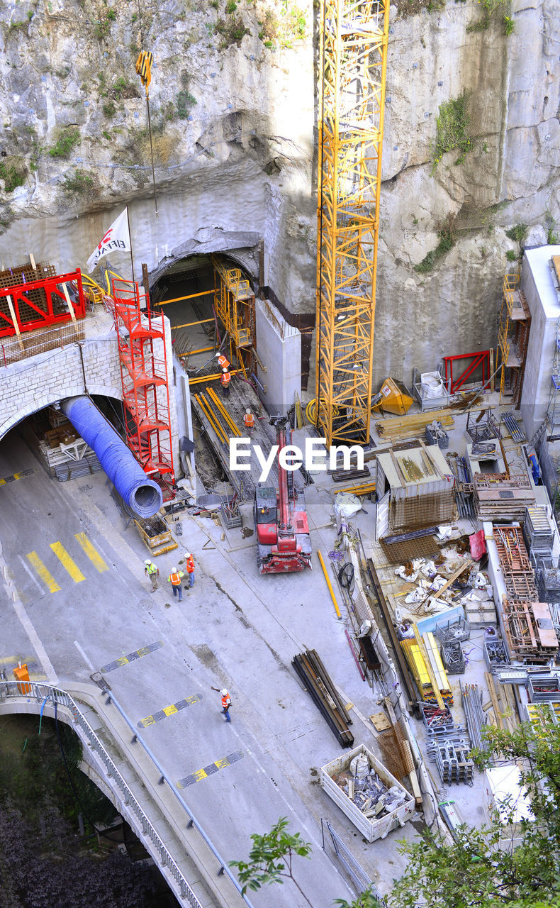 HIGH ANGLE VIEW OF CONSTRUCTION SITE AGAINST BUILDINGS