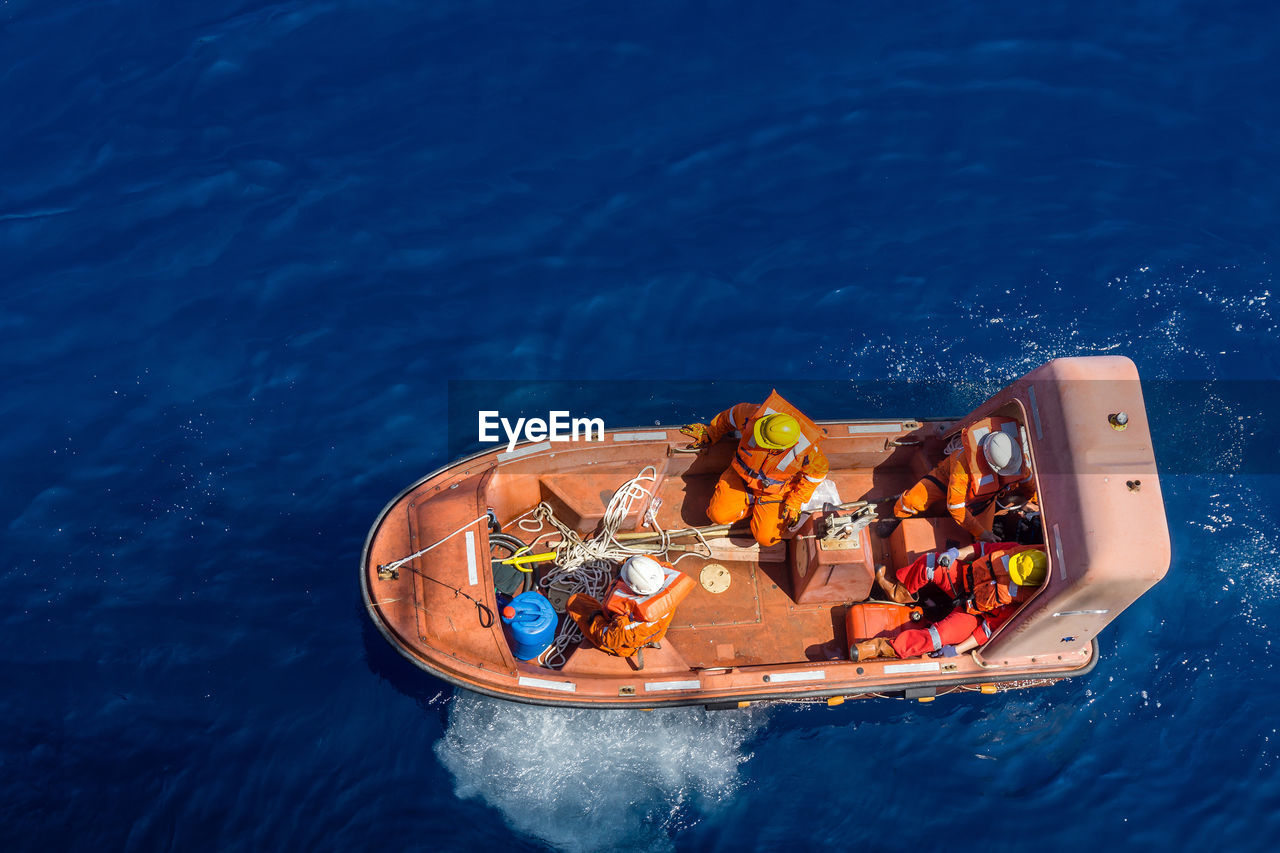 Fast rescue craft being deployed from a construction work barge at offshore terengganu oil field