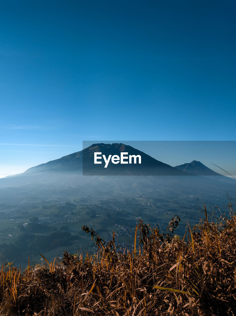 Scenic view of mountains against clear blue sky