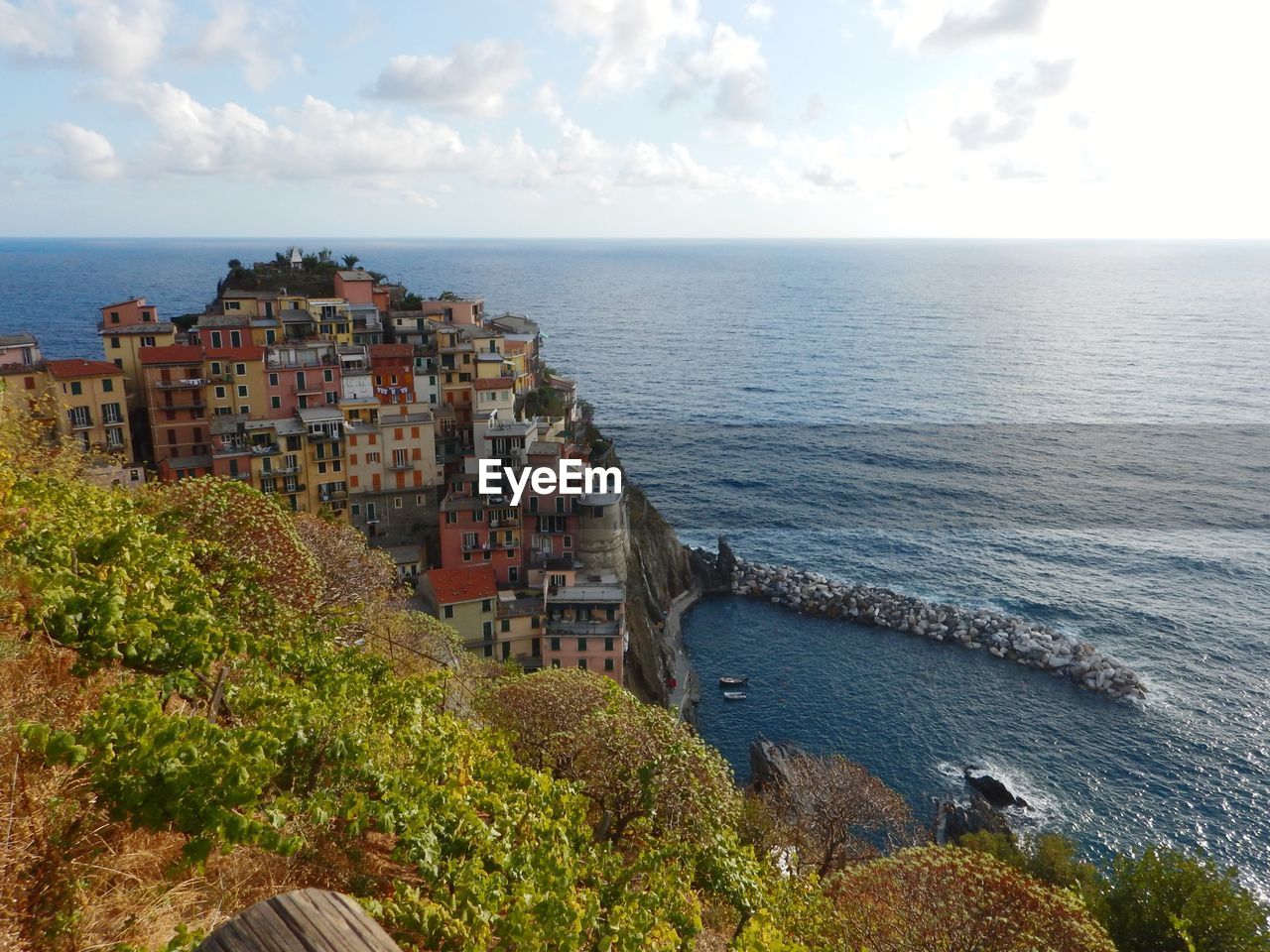 High angle view of townscape by sea against sky