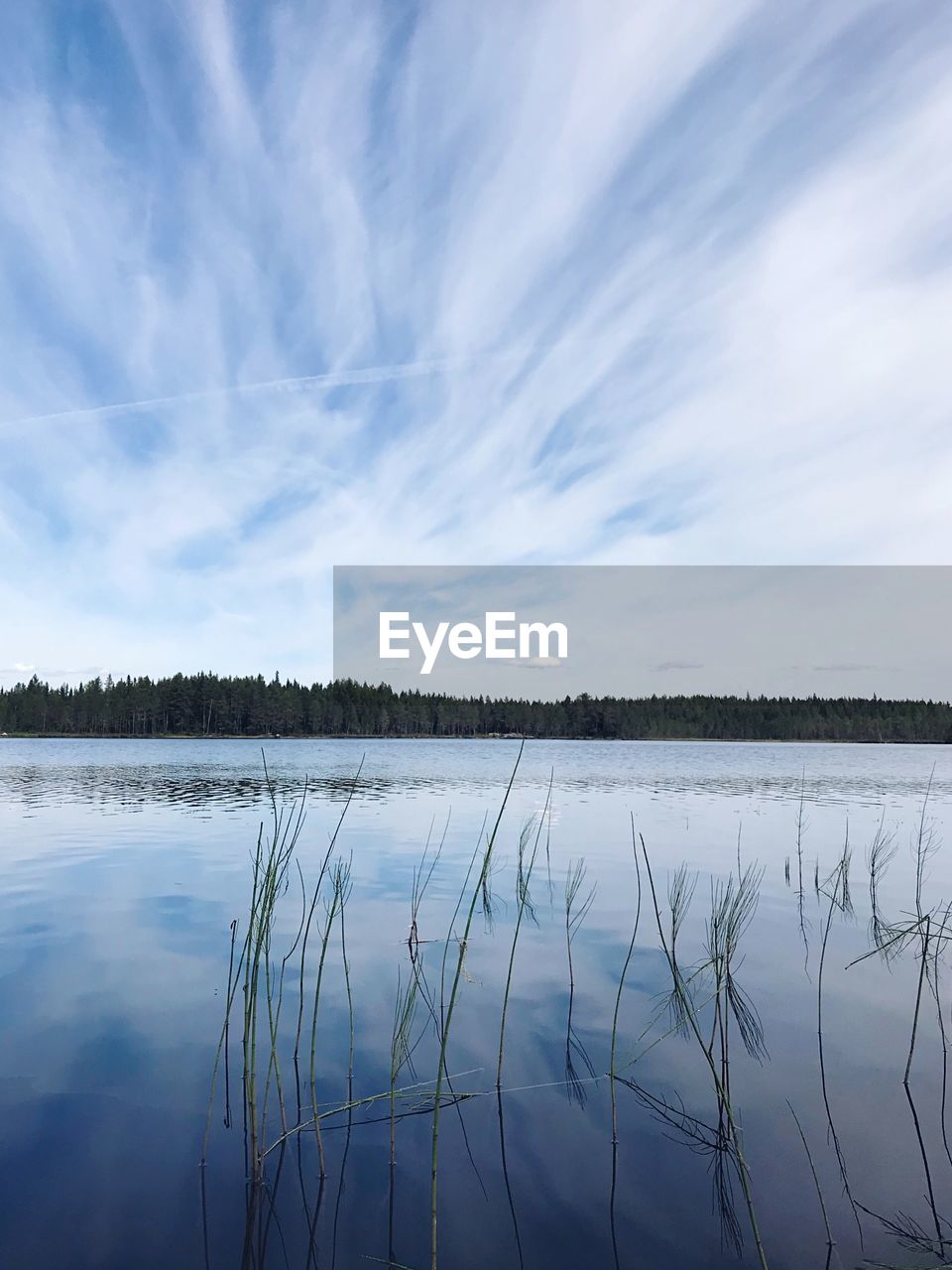 SCENIC VIEW OF LAKE AGAINST CLOUDY SKY