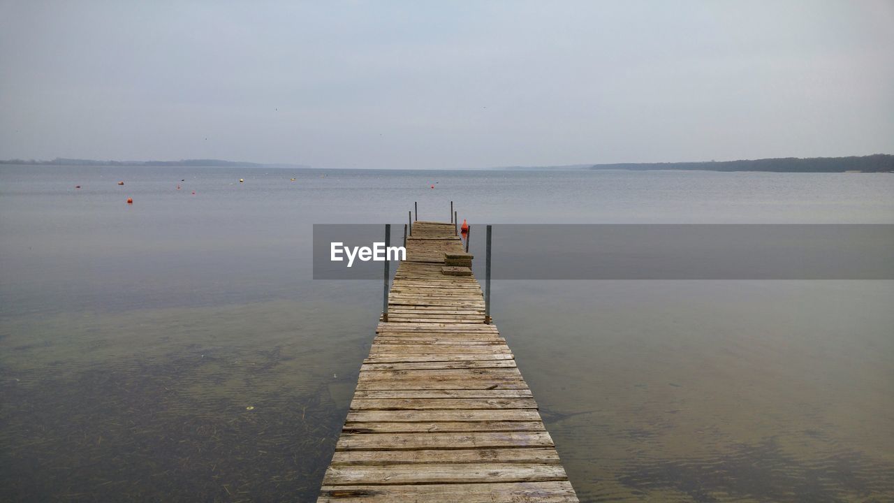 Pier over sea against sky