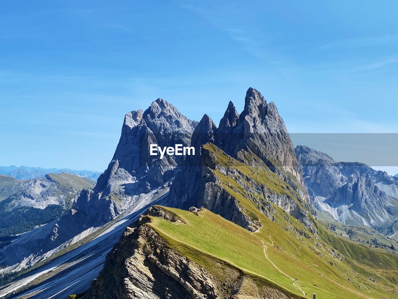 Panoramic view of mountains in summer against blue sky